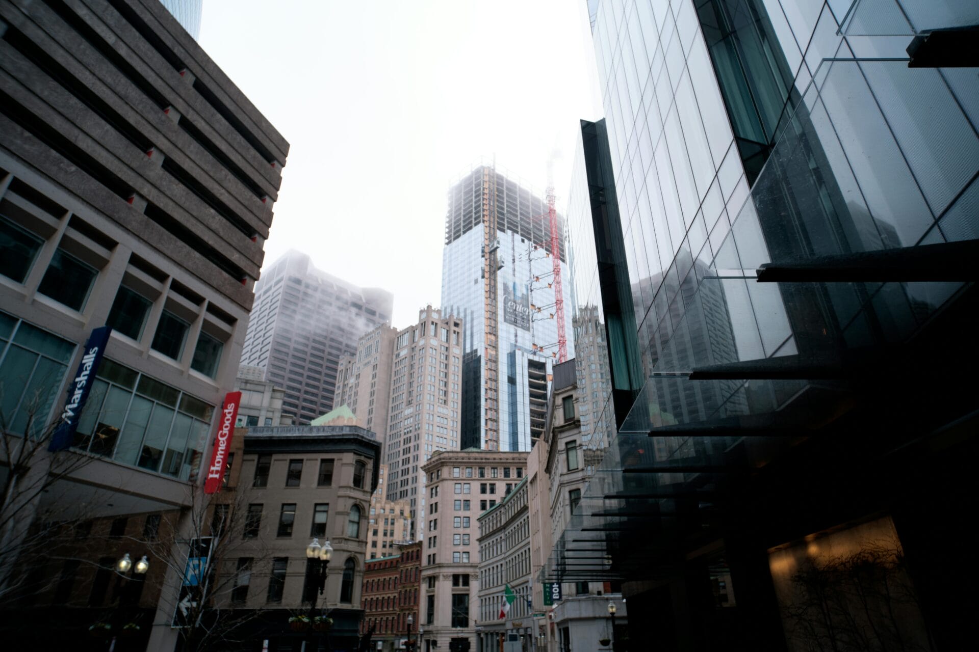 Skyscraper construction in a city with grey skies.