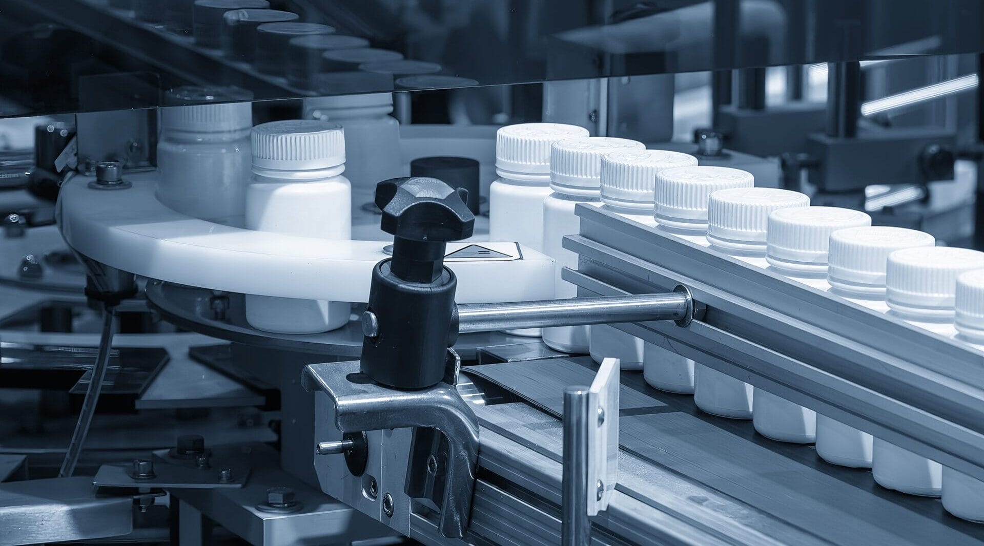 Medicine bottle filling process in the light blue scene.